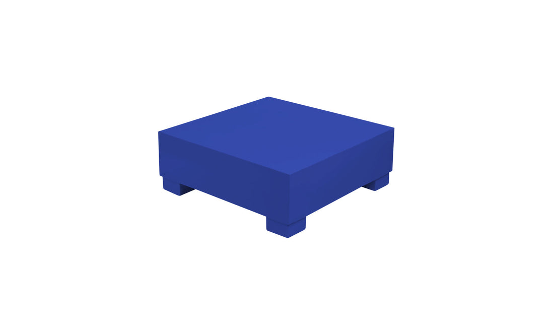 Introducing the Ledge Lounger Signature Coffee Table: a minimalist solid blue square block with four small legs, perfect for poolside essentials and featured on a pristine white background.