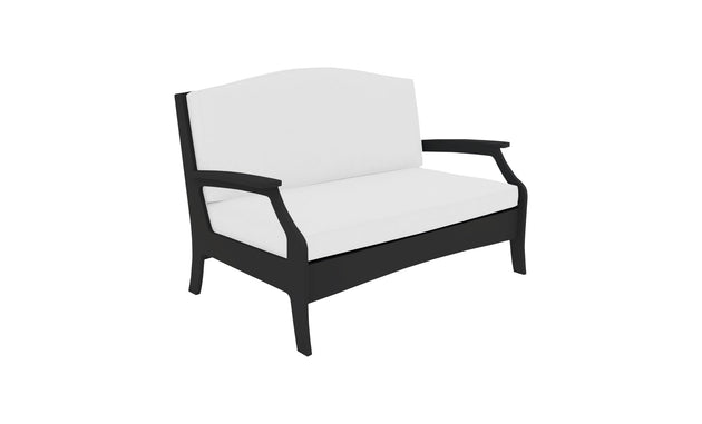 Meet the Legacy Loveseat by Ledge Lounger: a white cushioned masterpiece with a sleek black frame, curved armrests, and high backrest. Its modern, minimalist design enhances any indoor or outdoor space.