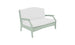 The Ledge Lounger Legacy Loveseat, a light green wooden bench with white cushioned seat and backrest, features curved armrests and a simple yet elegant design. Perfect for any outdoor space, its charm stands out against the white background.