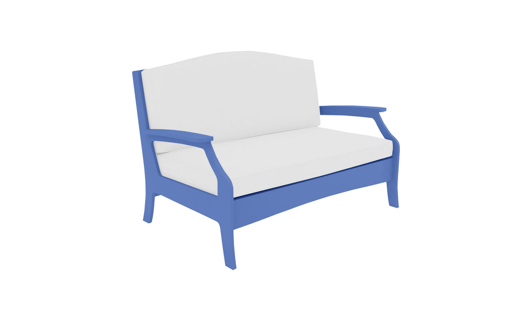 The Ledge Lounger Legacy Loveseat features a blue frame and white cushions, offering comfort with an arched backrest and armrests. Its simple, modern design makes it ideal for outdoor spaces.