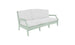 A Legacy Sofa from Ledge Lounger in light green with white cushions is set against a plain white background. The sofa has a modern design with armrests and three cushion sections, made in outdoor fabrics for lasting style and comfort.