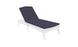 The sleek outdoor chaise lounge, set against a pristine white backdrop, showcases a dark Legacy Chaise Cushion by Ledge Lounger. Its modern design features curved legs and an adjustable backrest, with customization using premium outdoor fabric for enduring comfort and elegance.