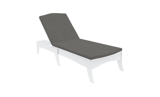 A sleek, minimalist outdoor chaise lounge features a white frame and dark gray Legacy Chaise Cushion by Ledge Lounger. The adjustable backrest and durable outdoor fabric make it perfect for the patio or poolside. The background is plain white.