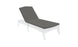 A sleek, minimalist outdoor chaise lounge features a white frame and dark gray Legacy Chaise Cushion by Ledge Lounger. The adjustable backrest and durable outdoor fabric make it perfect for the patio or poolside. The background is plain white.