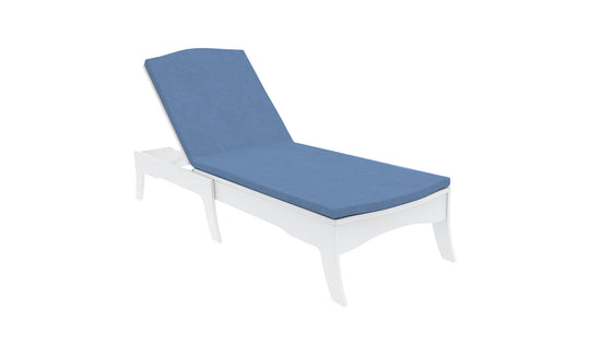A white chaise lounge chair features a Legacy Chaise Cushion by Ledge Lounger in blue, displayed on a white background. The backrest is slightly elevated, highlighting its customizable outdoor fabric options.