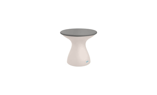 The Autograph Standard Side Table by Ledge Lounger is a small, modern stool with a gray flat top and white hourglass-shaped base, providing a sleek design that also functions as an outdoor side table.