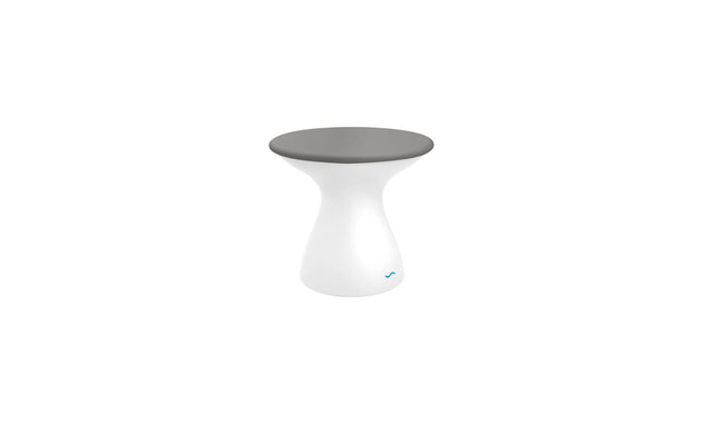 A modern, hourglass-shaped stool featuring a sleek gray top and glossy white base resembles the Autograph Standard Side Table by Ledge Lounger. Its minimalistic, contemporary design suits various interior styles.