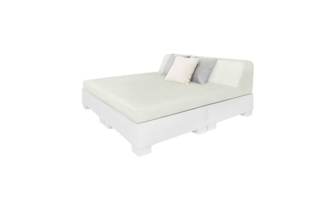 The Affinity Square Sunbed with Backrest Cushion by Ledge Lounger features a minimalist design, white base, light green mattress, simple headboard, and three pillows—two light-colored and one darker—perfect for creating an inviting poolside space.