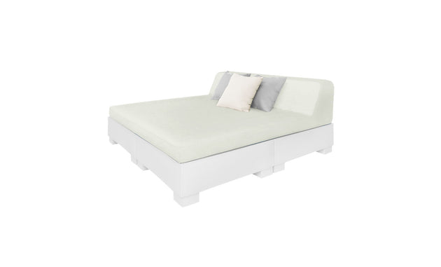 The Affinity Square Sunbed with Backrest Cushion by Ledge Lounger features a minimalist design, white base, light green mattress, simple headboard, and three pillows—two light-colored and one darker—perfect for creating an inviting poolside space.