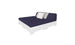 The Affinity Square Sunbed with Backrest Cushion by Ledge Lounger features a navy mattress and backrest on a white pallet-style frame, perfect for poolside relaxation. White and gray pillows add to its minimalist design, ideal for any outdoor space, with a plain white background enhancing its stylish simplicity.