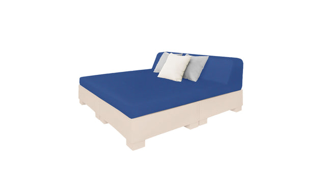 The Affinity Square Sunbed by Ledge Lounger is perfect for poolside relaxation, featuring a blue mattress and three pillows—two white, one light gray—on a light wooden frame. Its minimalist design and elegant simplicity beautifully complement any outdoor space.
