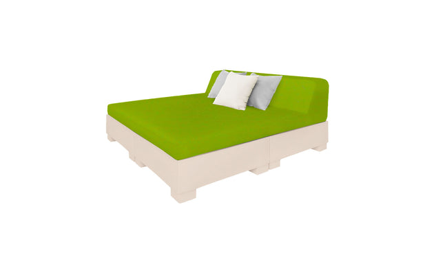 The Affinity Square Sunbed with Backrest Cushion by Ledge Lounger features a green mattress, two pillows (one white, one light gray), and a light base, ideal for relaxing poolside in your outdoor space against a pristine white backdrop.