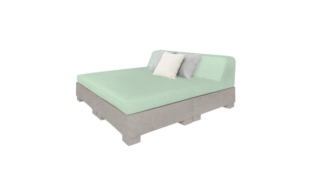 The Affinity Square Sunbed by Ledge Lounger presents a minimalist design featuring a light green mattress, two pillows (white and gray), and a light gray frame on block supports. Its partially upholstered headboard enhances any outdoor or poolside setting.