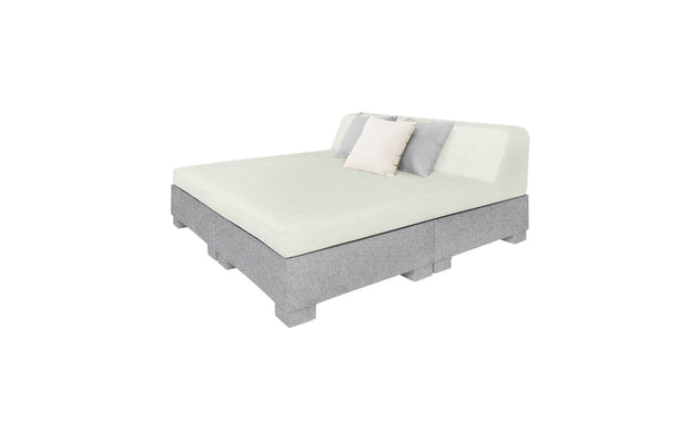 The Affinity Square Sunbed with Backrest Cushion by Ledge Lounger boasts a modern design featuring light gray upholstery, a simple headboard, and two pillows (white and gray). Ideal for elegant indoor use or poolside relaxation, this versatile sunbed effortlessly complements any setting.