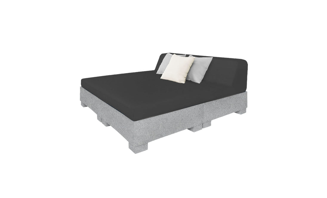 The Affinity Square Sunbed with Backrest Cushion by Ledge Lounger boasts a minimalist design with a gray mattress on a pallet-style base. It features black, white, and gray cushions against the backrest, perfect for poolside lounging or adding simple elegance to outdoor spaces.