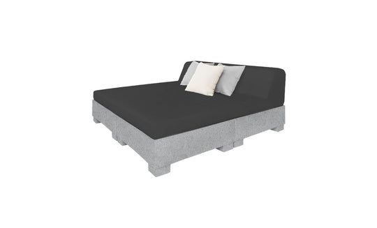 The Affinity Square Sunbed with Backrest Cushion by Ledge Lounger boasts a minimalist design with a gray mattress on a pallet-style base. It features black, white, and gray cushions against the backrest, perfect for poolside lounging or adding simple elegance to outdoor spaces.