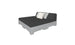 The Affinity Square Sunbed with Backrest Cushion by Ledge Lounger boasts a minimalist design with a gray mattress on a pallet-style base. It features black, white, and gray cushions against the backrest, perfect for poolside lounging or adding simple elegance to outdoor spaces.