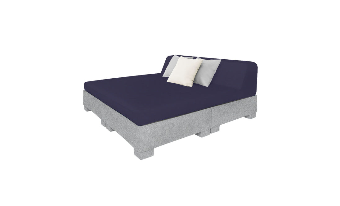 The Ledge Lounger Affinity Square Sunbed with Backrest Cushion boasts a modern, minimalist design featuring a gray upholstered base and dark blue mattress. It includes two pillows in light gray and white, perfect for poolside relaxation or outdoor enhancement against a white backdrop.