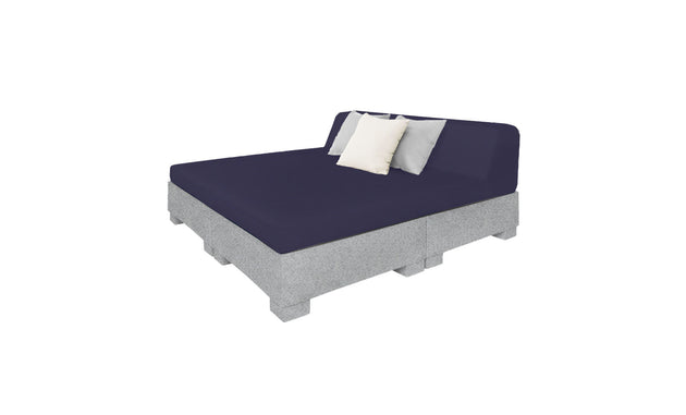 The Ledge Lounger Affinity Square Sunbed with Backrest Cushion boasts a modern, minimalist design featuring a gray upholstered base and dark blue mattress. It includes two pillows in light gray and white, perfect for poolside relaxation or outdoor enhancement against a white backdrop.