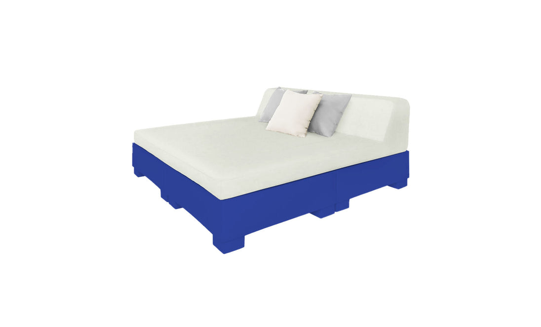 The Affinity Square Sunbed with Backrest Cushion by Ledge Lounger features a minimalist design with a white mattress and pillows on a blue base, seamlessly integrating the headrest. Perfect for serene outdoor settings, it invites poolside relaxation against a plain white background.