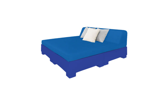 Explore the Affinity Square Sunbed with Backrest Cushion by Ledge Lounger. This blue upholstered sunbed has a tall angled headboard and rests on a matching base, featuring two square pillows—white and light blue. Ideal for poolside relaxation under a clear sky.