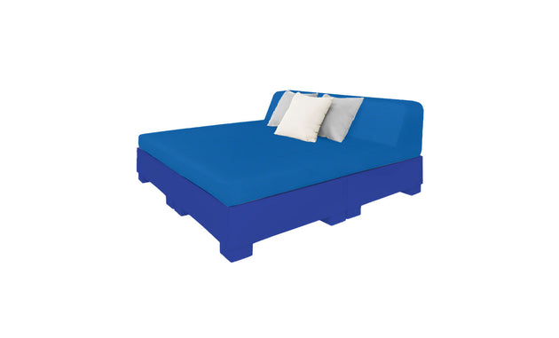 Explore the Affinity Square Sunbed with Backrest Cushion by Ledge Lounger. This blue upholstered sunbed has a tall angled headboard and rests on a matching base, featuring two square pillows—white and light blue. Ideal for poolside relaxation under a clear sky.