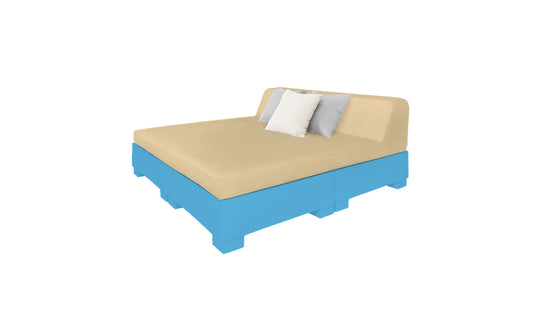The Affinity Square Sunbed with Backrest Cushion by Ledge Lounger boasts a beige mattress and backrest on a blue pallet-style frame, complemented by minimalist design elements, including two white and one gray pillow, perfect for poolside relaxation against a sleek white backdrop.