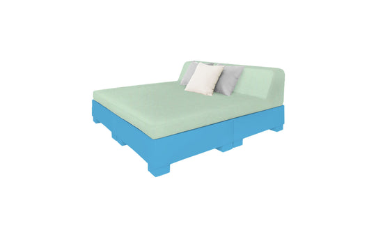 Experience the Affinity Square Sunbed with Backrest Cushion by Ledge Lounger, featuring a light green mattress and pillows on a bright blue platform. This setup offers a poolside relaxing vibe, ideal for any outdoor space or serene setting against a white backdrop.