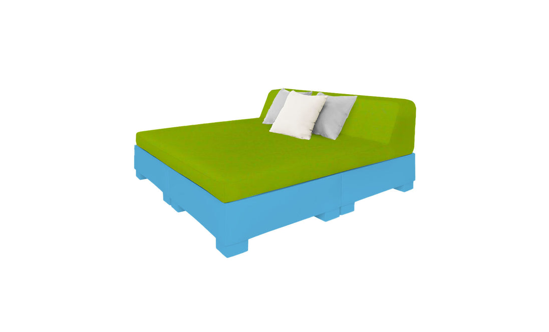 Discover the Affinity Square Sunbed with Backrest Cushion by Ledge Lounger: a modern outdoor sofa featuring a green cushion and two white pillows atop a blue pallet-style base. Its minimalist design and vivid colors create a contemporary look perfect for poolside relaxation.