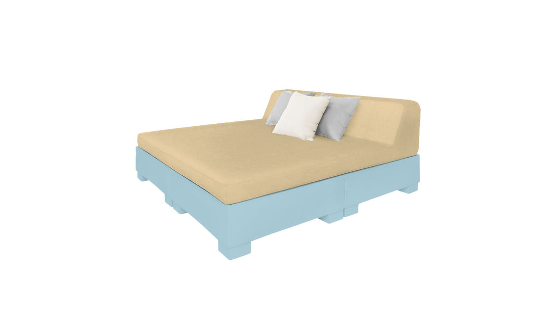 The Affinity Square Sunbed by Ledge Lounger features a beige cushioned sofa with a light blue wooden base, two grey pillows, and one white pillow, perfect for poolside relaxation against a plain white background.