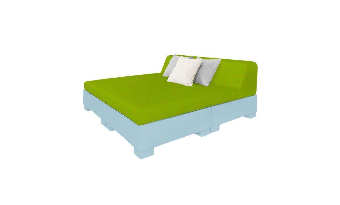 Relax poolside with the modern Affinity Square Sunbed by Ledge Lounger, featuring a green mattress and light blue base. Enhance your outdoor space with two plush pillows—one white, one gray—set against a pristine white backdrop.