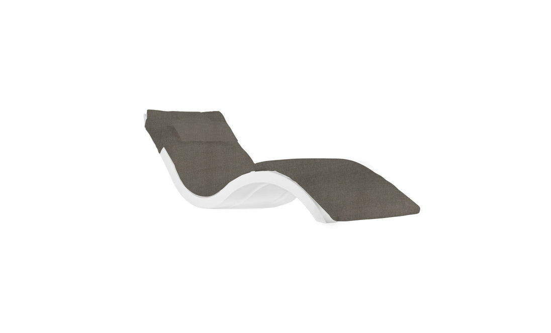 A sleek, modern lounge chair from Ledge Lounger’s Signature Chaise Cushion collection with a curvy white frame and dark grey cushion, featuring a wave-like design complemented by a headrest pillow on a plain white background.