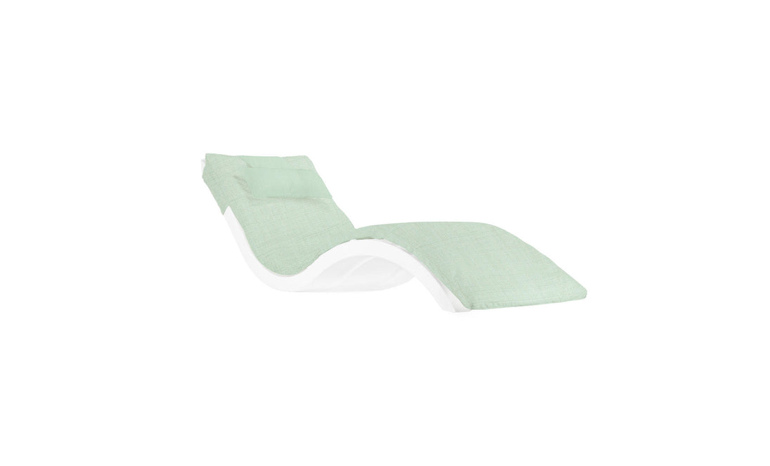 The Signature Chaise Cushion by Ledge Lounger features a modern wave-shaped design with a white frame and light green cushion. Its sleek, minimalist style suits contemporary interiors, and the slightly elevated headrest adds comfort.