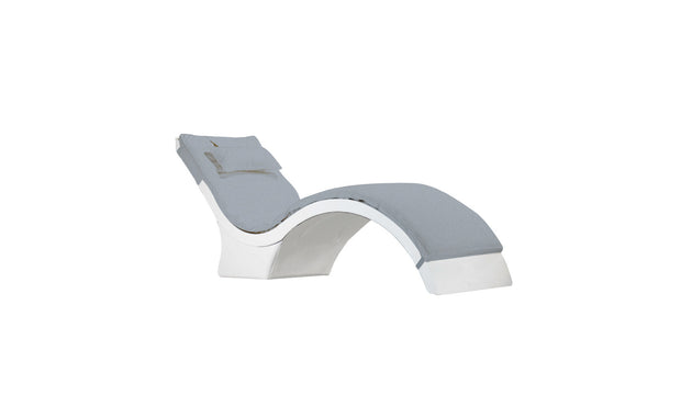The Signature Chaise Cushion by Ledge Lounger is a modern, curved lounge chair with a gray cushioned seat and backrest, plush headrest pillow, and a sleek white structure for a stylish minimalist design.