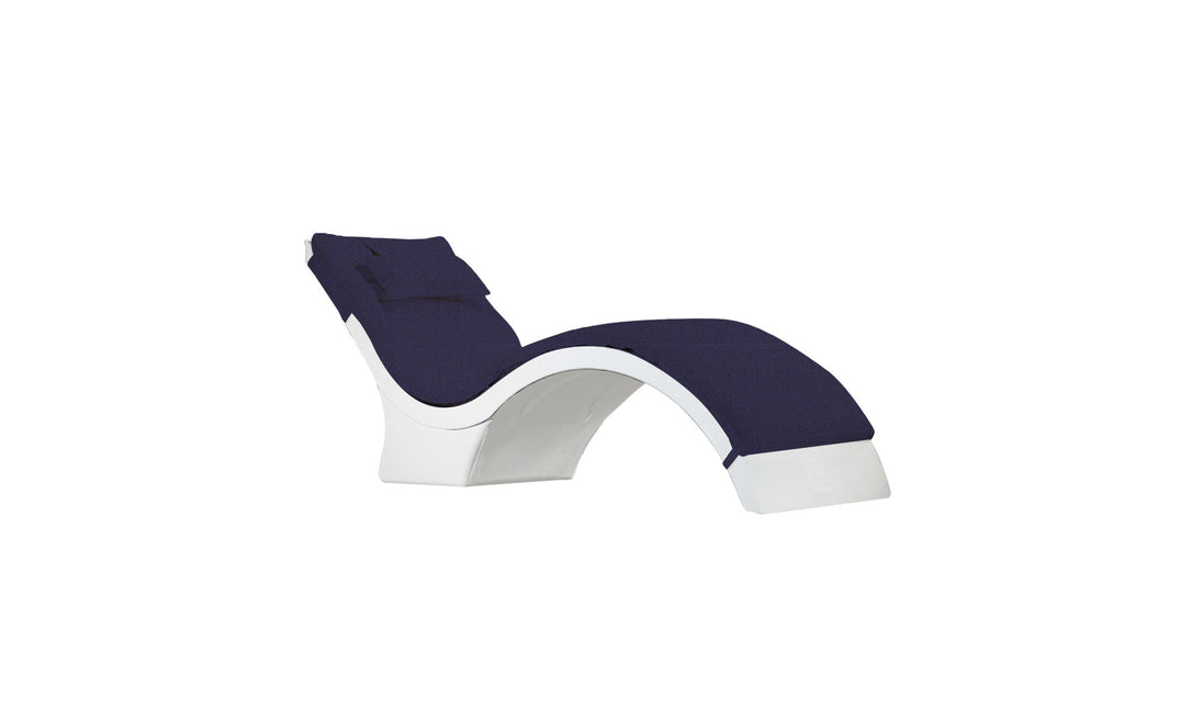 The Signature Chaise Deep Cushion by Ledge Lounger features a sleek, minimalist curved design in white and navy blue with an attached headrest pillow, set against a white backdrop. Final Sale.