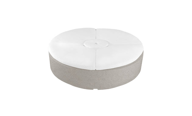 The Signature Round Sunbed by Ledge Lounger features a modern round design with a light gray fabric base and a white cushioned top with central tufted button, perfect for adding style and comfort to any patio or garden.