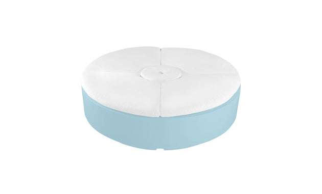 The Signature Round Sunbed by Ledge Lounger features a light blue base and white cushioned top, perfect for enhancing any outdoor space. Its tufted design with a central button adds modern appeal, combining style and relaxation.
