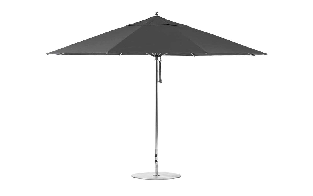 The Essential Fiberglass Umbrella - 13 Octagon Pulley by Ledge Lounger includes a marine-grade dark canopy and a slim aluminum pole. It has a stable, round base and features a wide, circular covering when open.