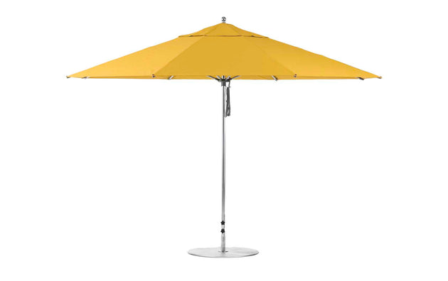 A large outdoor umbrella with a round base and durable aluminum pole, the 13 octagon Essential Fiberglass Umbrella by Ledge Lounger is fully open.