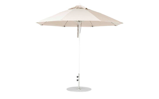 A 9 Octagon Pulley Essential Fiberglass Umbrella by Ledge Lounger stands upright on a round metal base. Its beige, marine-grade fabric canopy is supported by sturdy metal ribs, ensuring durability against the elements.
