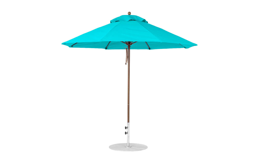 The Essential Fiberglass Umbrella - 9 Octagon Pulley by Ledge Lounger features a turquoise hue, metal pole, and round base. Made with marine-grade fabrics, its classic design includes a vented canopy ideal for shade on sunny days.