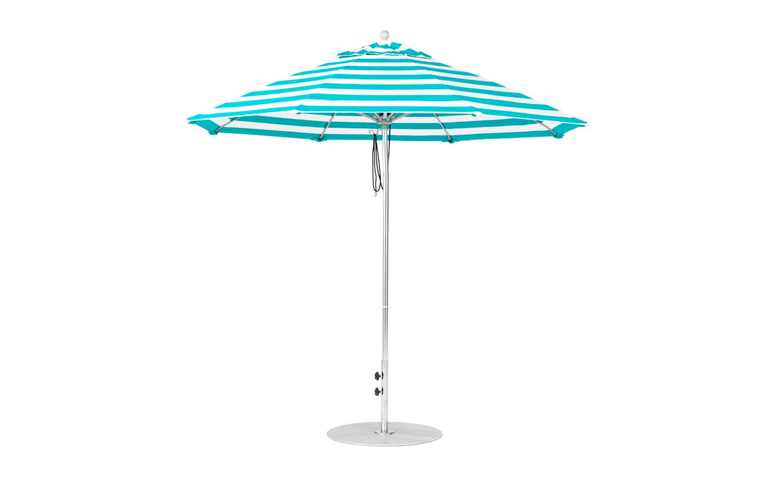 The Essential Fiberglass Umbrella - 9 Octagon Pulley by Ledge Lounger features blue and white stripes, a sturdy metal pole, and a round base. Its wide octagonal canopy is crafted from marine-grade fabrics for shore-side durability.