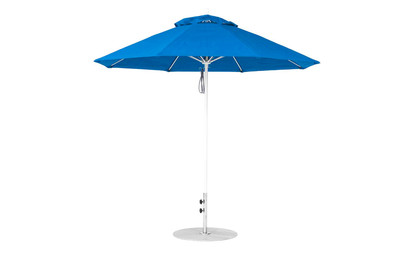 A blue Essential Fiberglass Umbrella by Ledge Lounger, featuring a 9 octagon canopy with a vented top, rests on a white pole and sturdy round base. It includes a manual crank handle for easy operation.