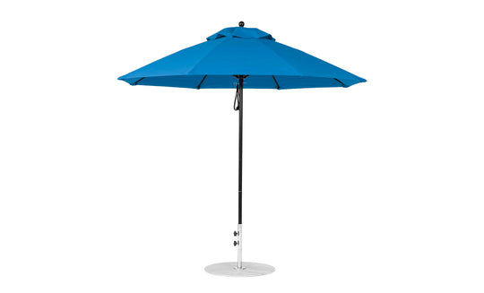 The Ledge Lounger Essential Fiberglass Umbrella - 9 Octagon Pulley features a large blue canopy with eight triangular panels, a black pole, and a round silver base. Made with durable marine-grade fabrics, its simple modern design enhances any outdoor setting.