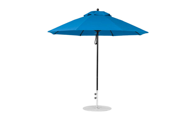 The Ledge Lounger Essential Fiberglass Umbrella - 9 Octagon Pulley features a large blue canopy with eight triangular panels, a black pole, and a round silver base. Made with durable marine-grade fabrics, its simple modern design enhances any outdoor setting.