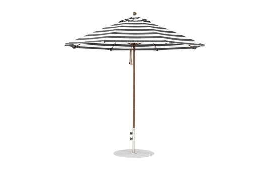 A 9 octagon black-and-white striped Essential Fiberglass Umbrella by Ledge Lounger with marine-grade fabric, featuring a wooden pole on a round base. The umbrella is open and shown from the side.
