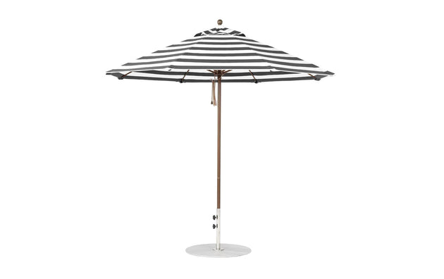 A 9 octagon black-and-white striped Essential Fiberglass Umbrella by Ledge Lounger with marine-grade fabric, featuring a wooden pole on a round base. The umbrella is open and shown from the side.