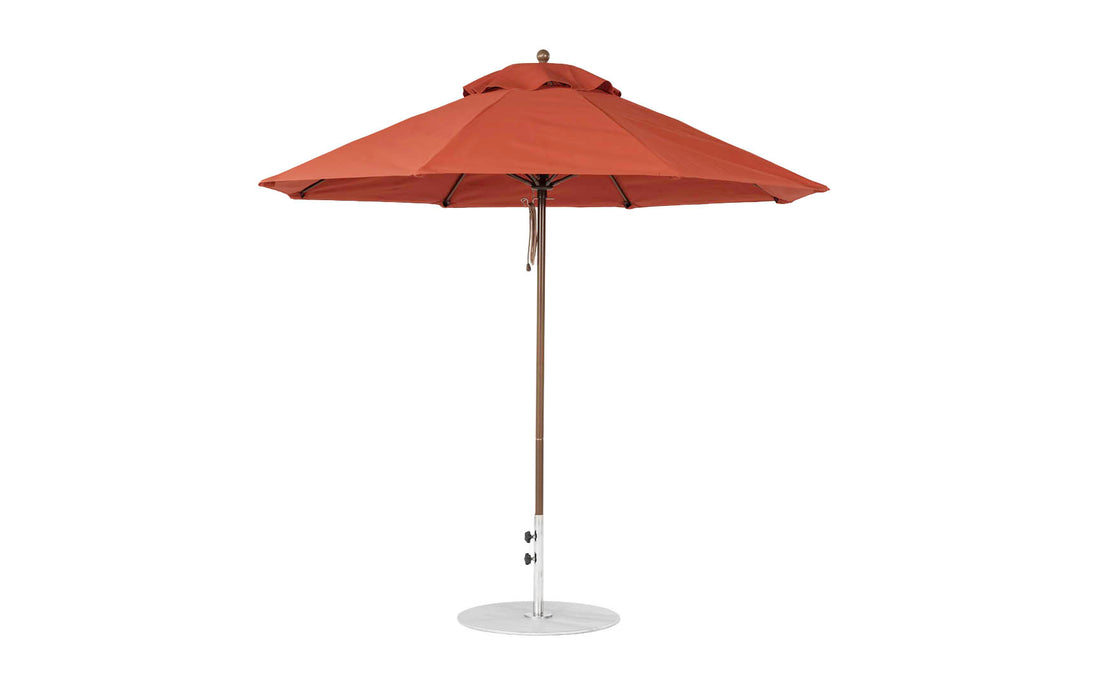The Ledge Lounger Essential Fiberglass Umbrella - 9 Octagon Pulley with a sleek metal pole and circular base stands open, showcasing its brown, pointed top. Crafted from marine-grade fabrics, it provides reliable shade and ensures sturdiness and weather resistance for long-lasting use.