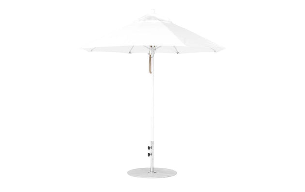 The Essential Fiberglass Umbrella - 7.5 Octagon Pulley by Ledge Lounger is a white, wind-resistant patio umbrella with a modern design featuring a circular base and slender pole, supporting an elegant canopy made from marine-grade fabric. Fully opened, it showcases its symmetrical structure against a plain background.