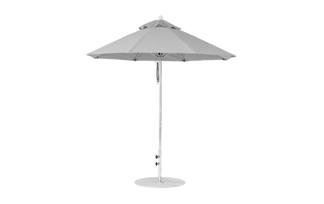 The Ledge Lounger Essential Fiberglass Umbrella features a large 7.5 octagon grey canopy made from marine-grade fabrics, with a straight metal pole on a flat circular base, ideal for outdoor use.